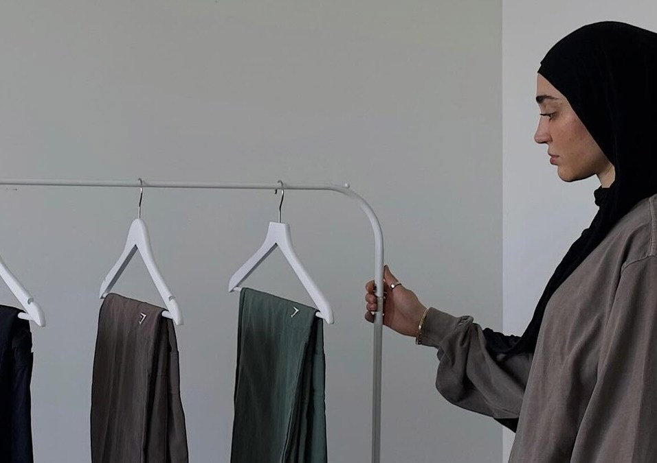 Girl wearing a hijab choosing clothes