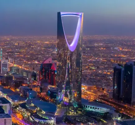 Night view of Riyadh, Saudi Arabia, featuring the illuminated Kingdom Centre Tower