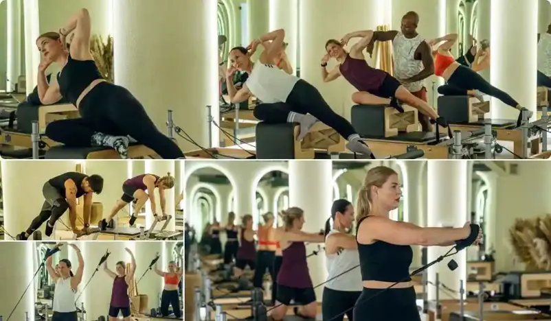 dynamic Pilates class with participants engaged in various exercises using Reformer machines at gymnation