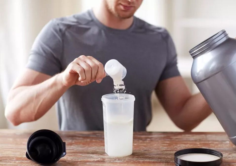 A man puts protein in his drink