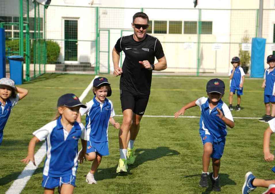 The coach runs with the children