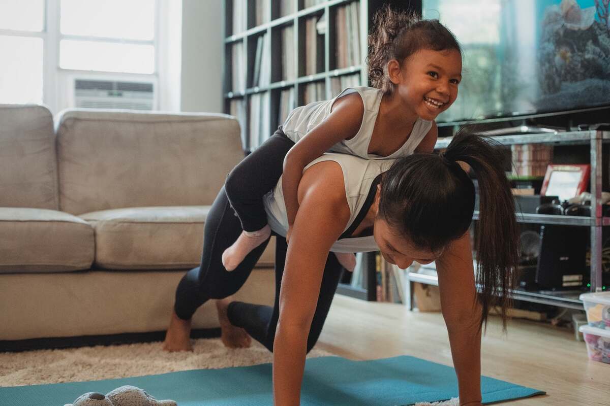 A girl and her mother exercising