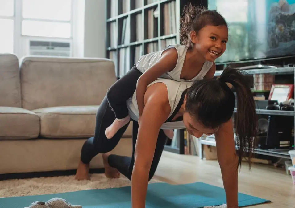 A girl and her mother exercising