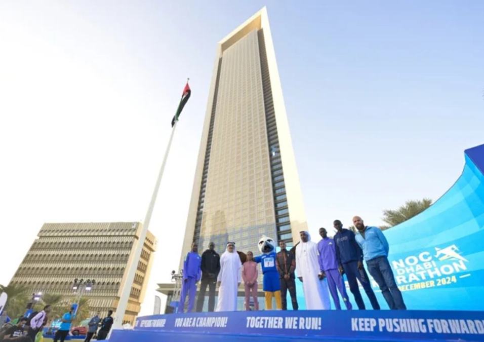 Officials and participants pose after a press conference at the Marathon Village on Thursday.