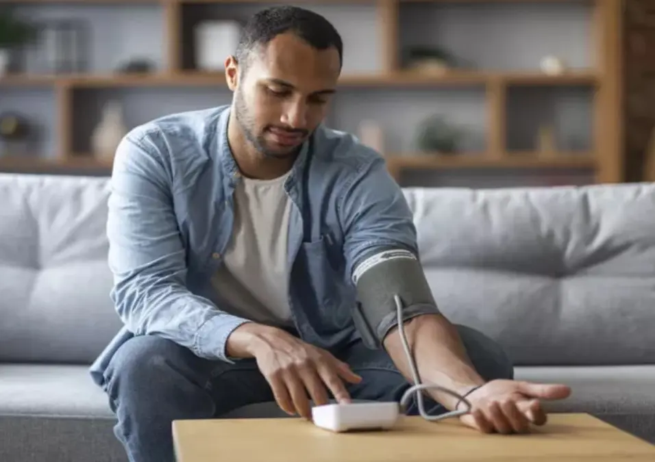 رجل يقيس ضغط دمه بجهاز منزلي، يقترح خطوات سريعة ونتائج مضمونة لخفض الضغط المرتفع فوراً.